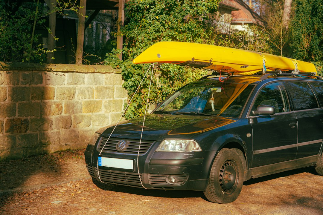 Yellow kayak secured to a vehicle roof rack