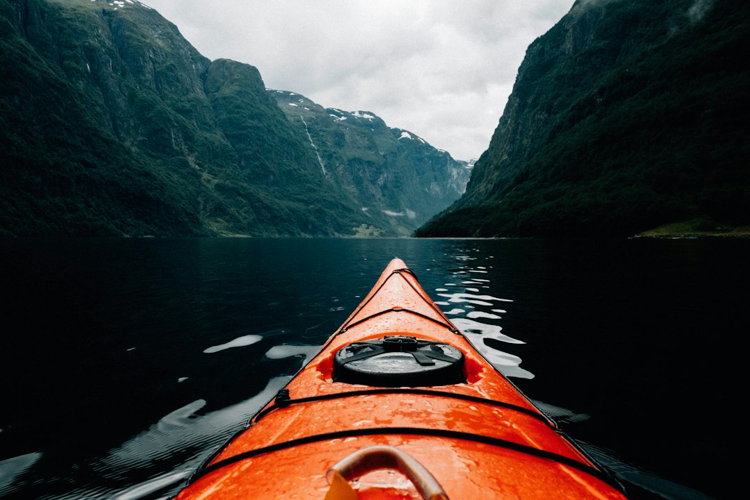 Kayaker paddling through a mountain valley